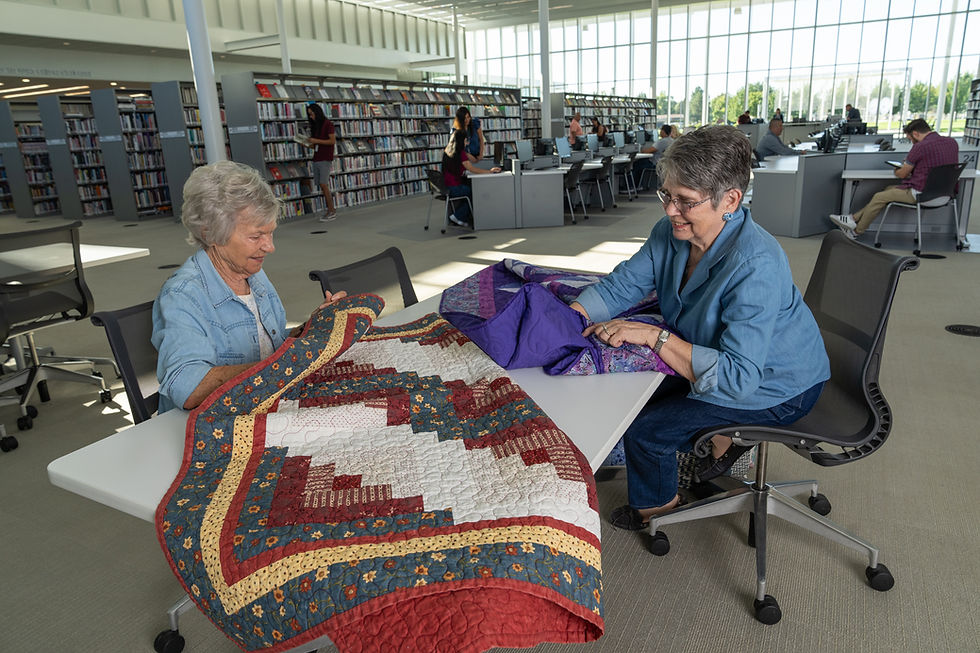 women working on quilts at Weber County Library table