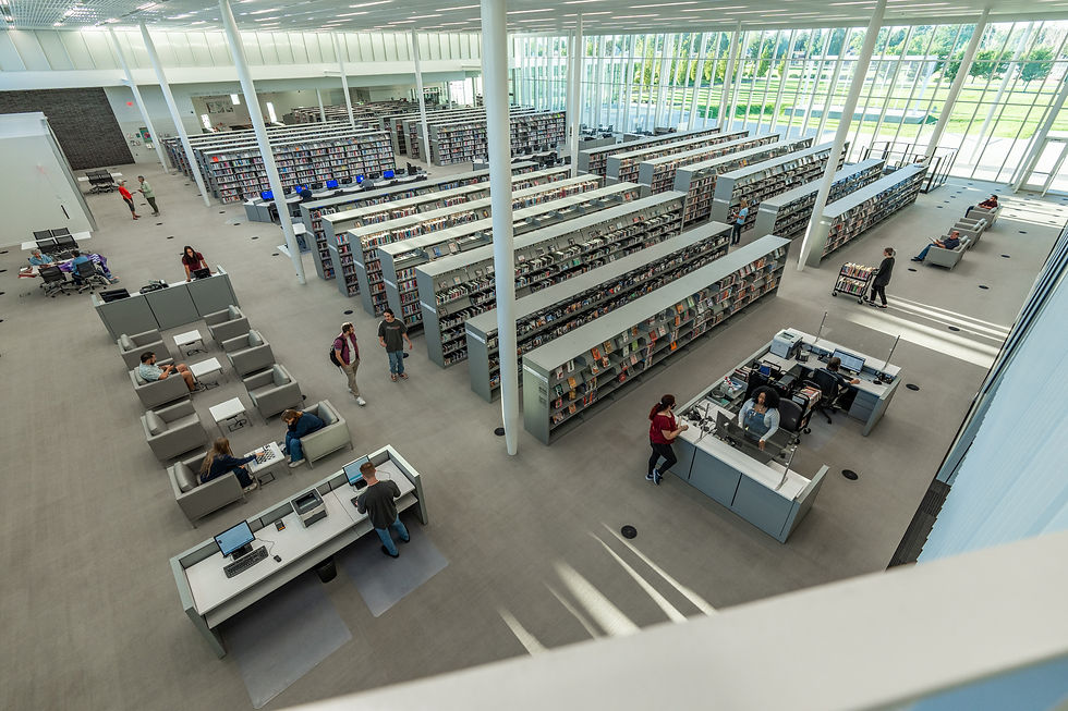 Looking down into Weber County Library with bookshelves and library staff and people
