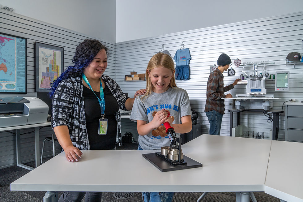 librarian helping a child in the Weber County Library makerspace