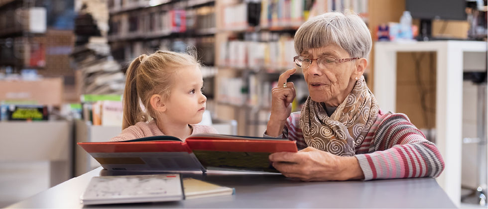 woman reading to a child inside a library