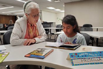 woman reading with a child at the Weber County Library