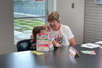 woman reading with a child at the Weber County Library