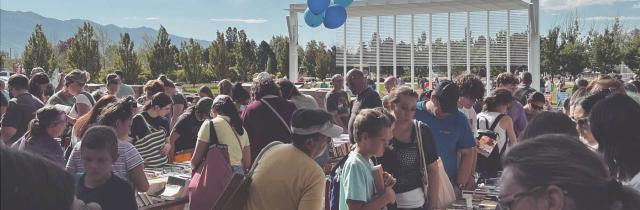 crowd of people around tables with books